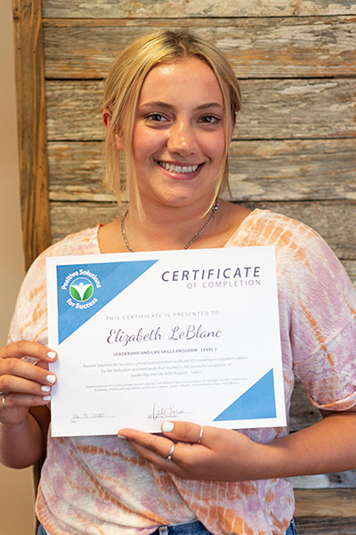 teen holding certificate