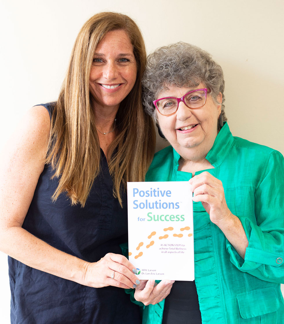 jill with teacher holding book